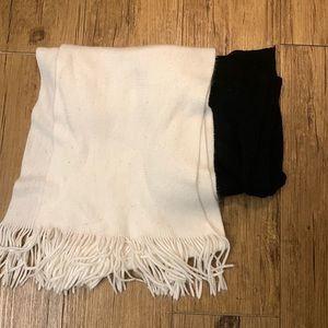two scarves one black one white with fringe